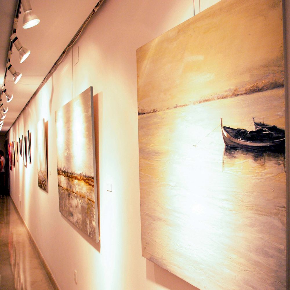 Photo of Andreina Scanu's paintings in an exhibition.